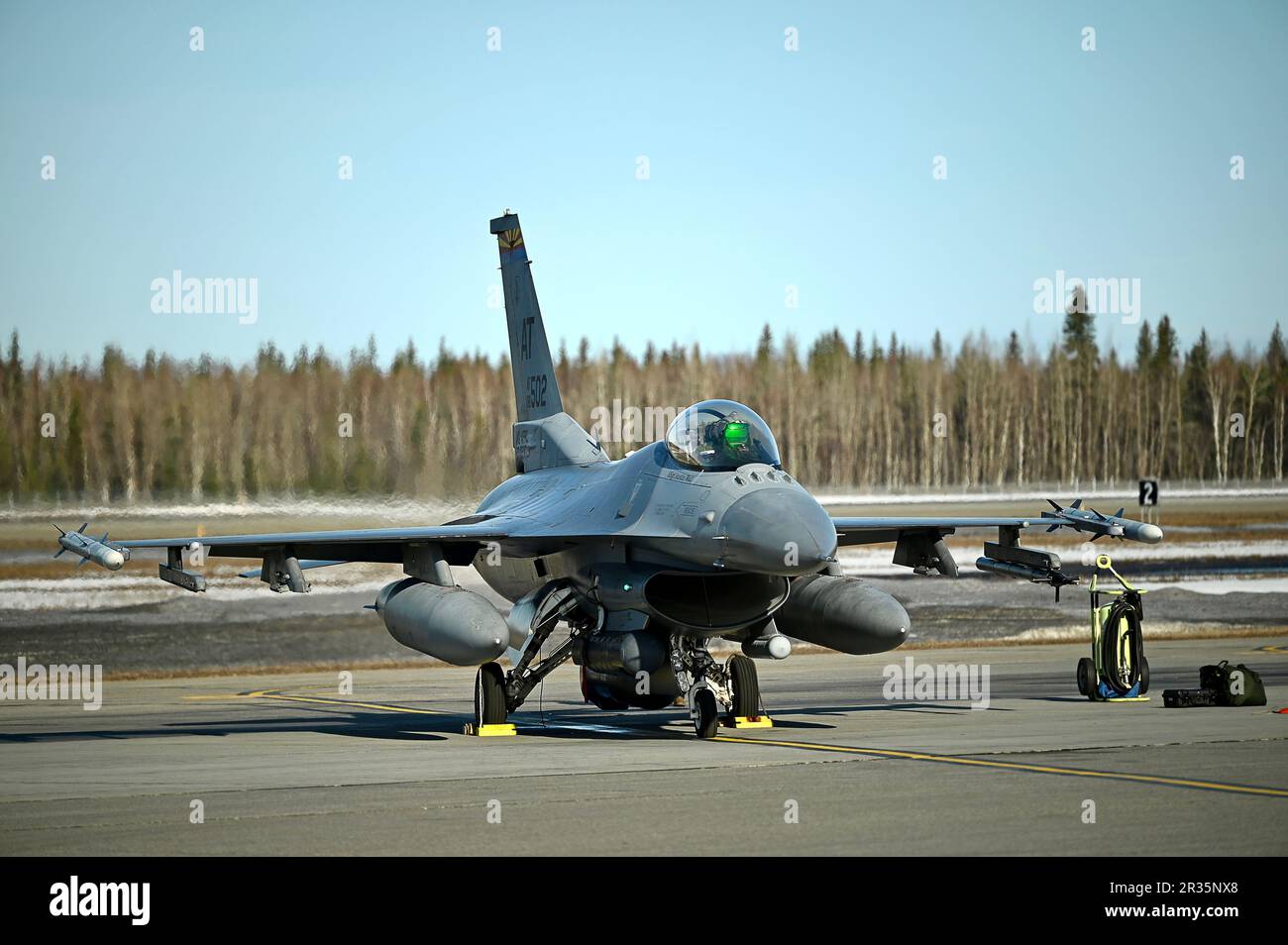 An F-16 Fighting Falcon, assigned to the Air National Guard Air Force Reserve Command Test Center, prepares to launch at Eielson Air Force Base, Alaska, May 5, 2023, during Northern Edge 2023. The exercise provided the opportunity for AATC personnel to test the “angry kitten” combat pod, an Electronic Warfare (EW) countermeasure system that can be housed in removable, adaptable pods under aircraft wings or fuselages. NE23 provides the opportunity to hone current and test future applications of combat operations and weapons capabilities. (U.S. Air National Guard photo by Master Sgt. Amber Monio Stock Photo