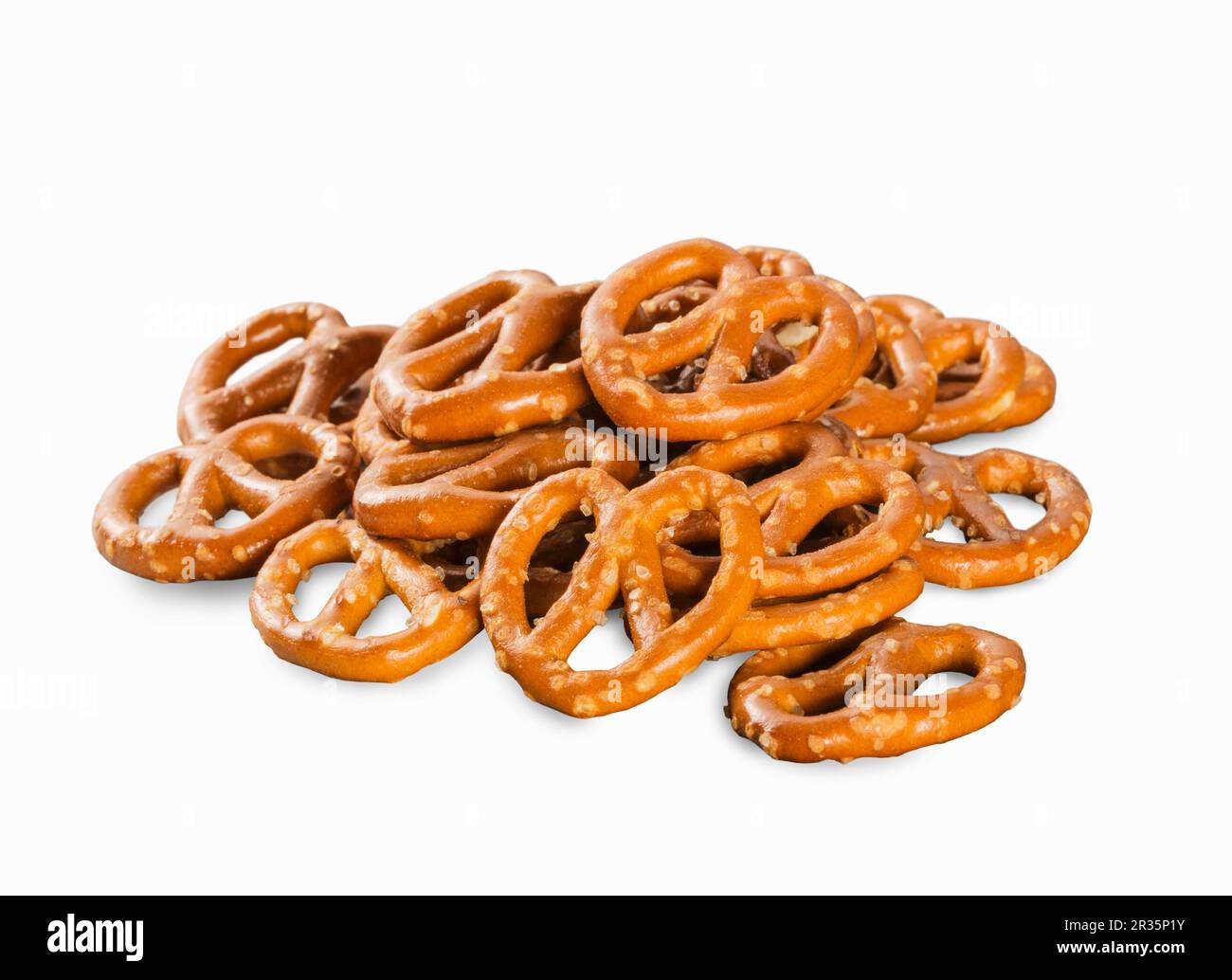 A pile of mini salted pretzels on a white surface Stock Photo Alamy