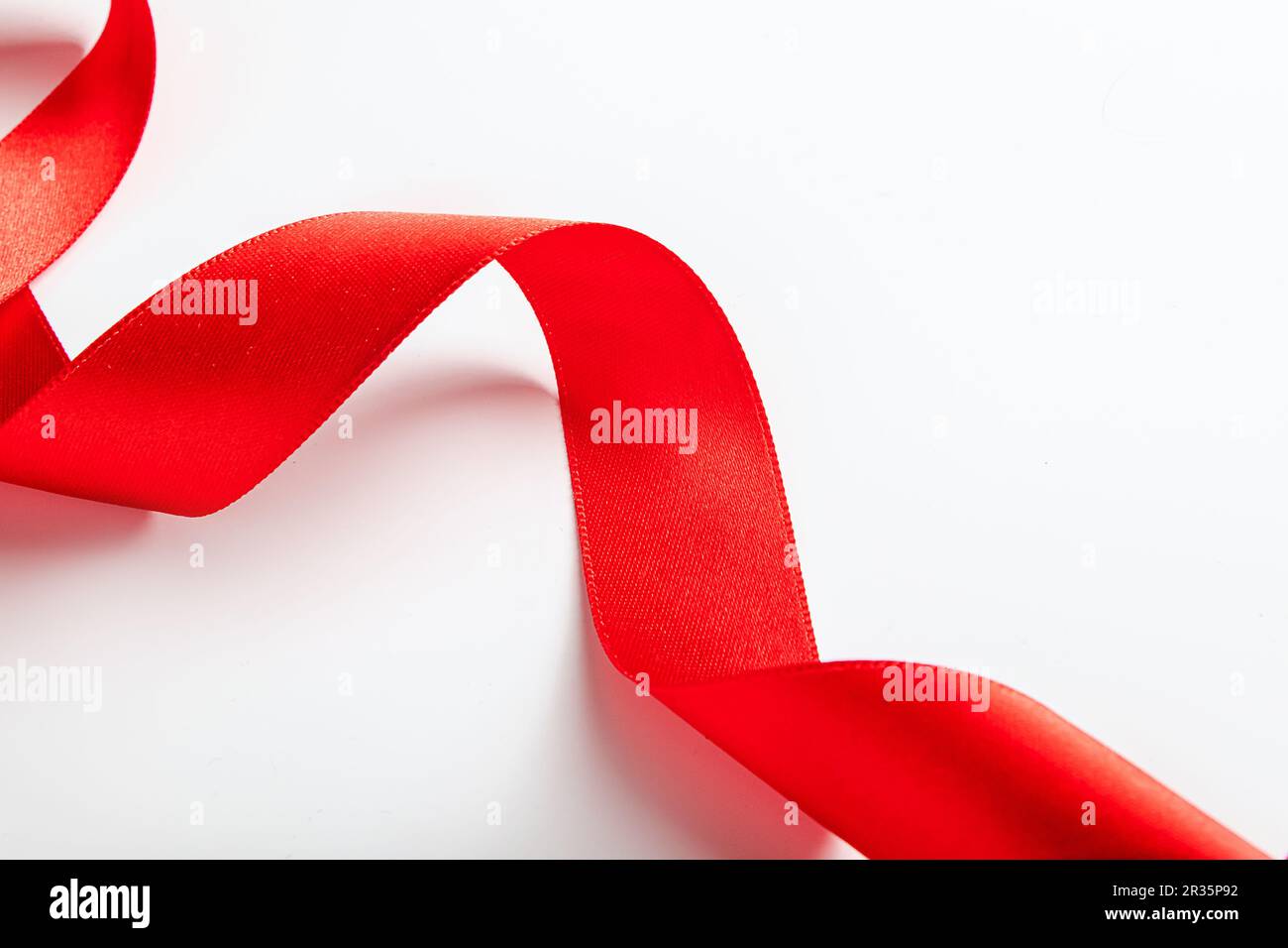 Premium Photo  Twisted red silk ribbon with bends isolated on white wall