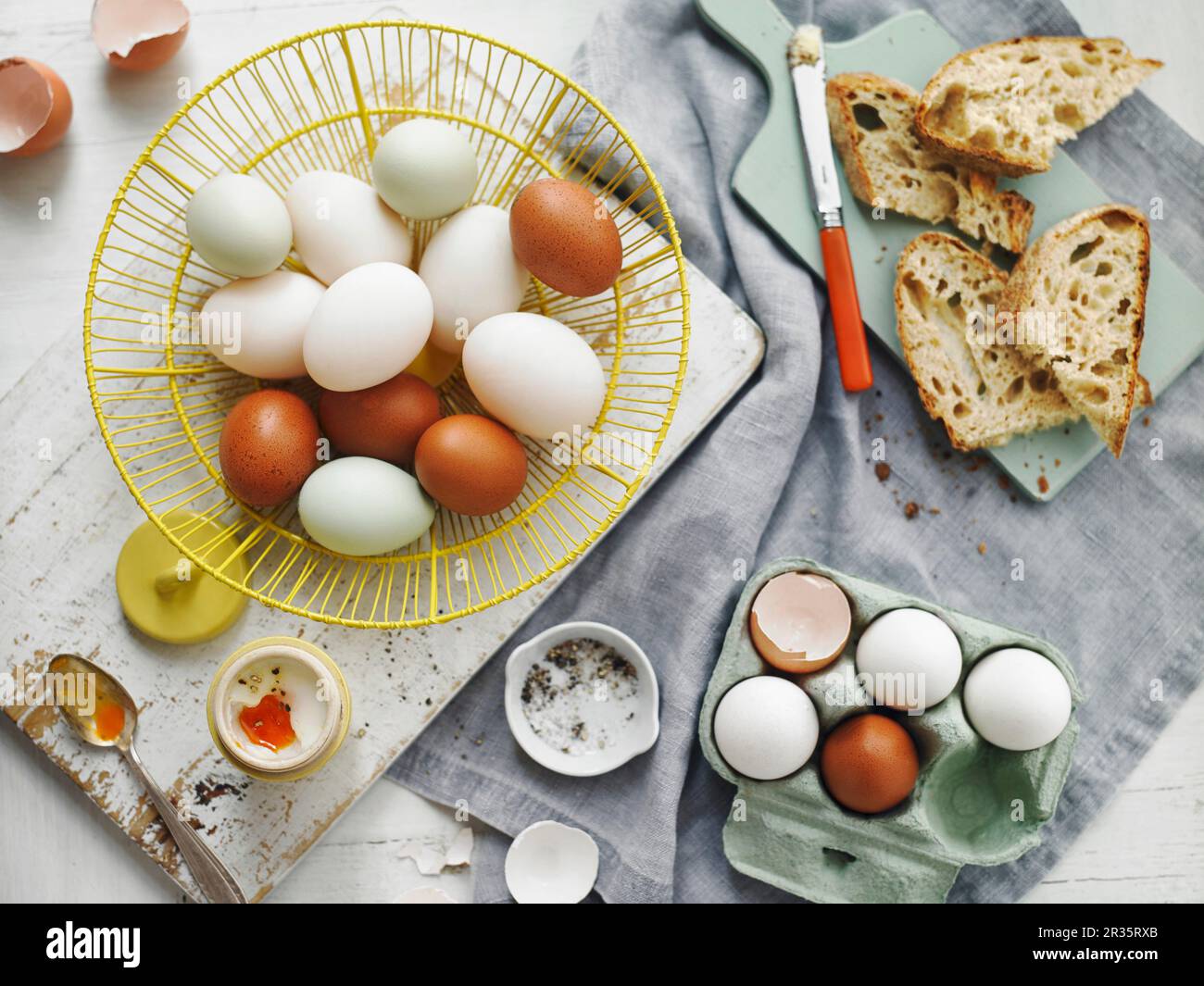 Brown and white eggs in a basket and in an egg box Stock Photo