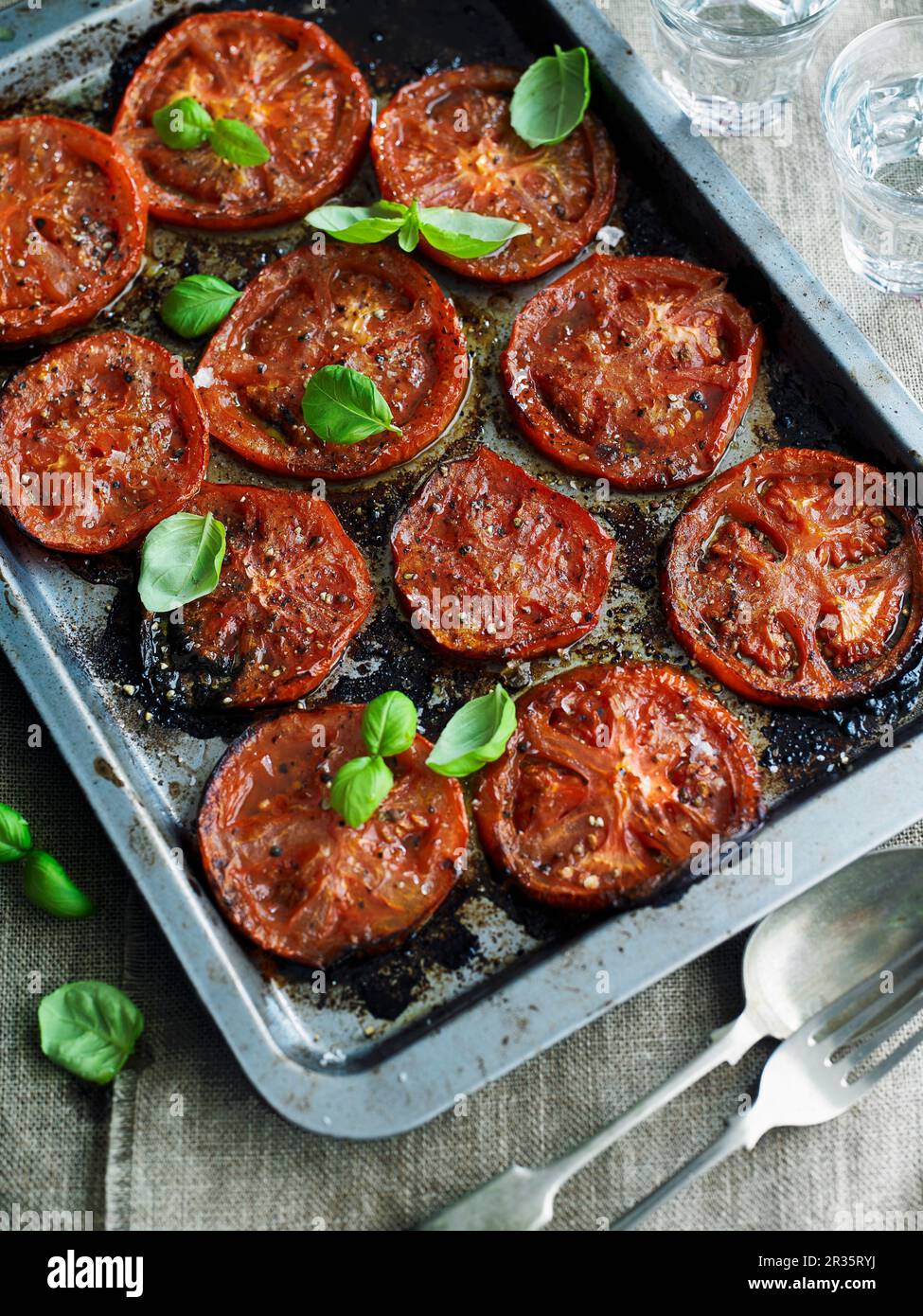 Oven-baked tomatoes with basil Stock Photo - Alamy