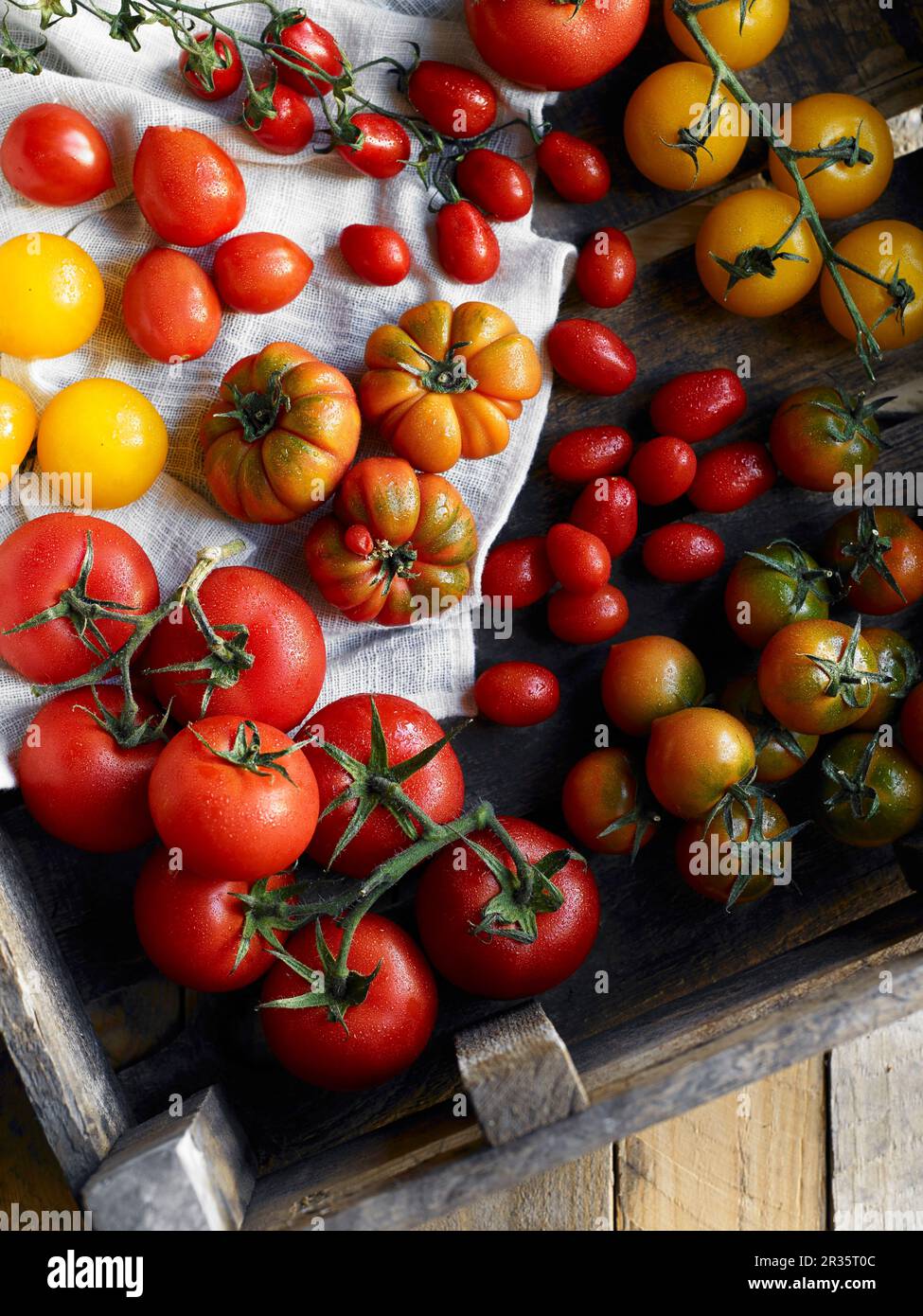 Various types of tomatoes in a wooden crate Stock Photo Alamy
