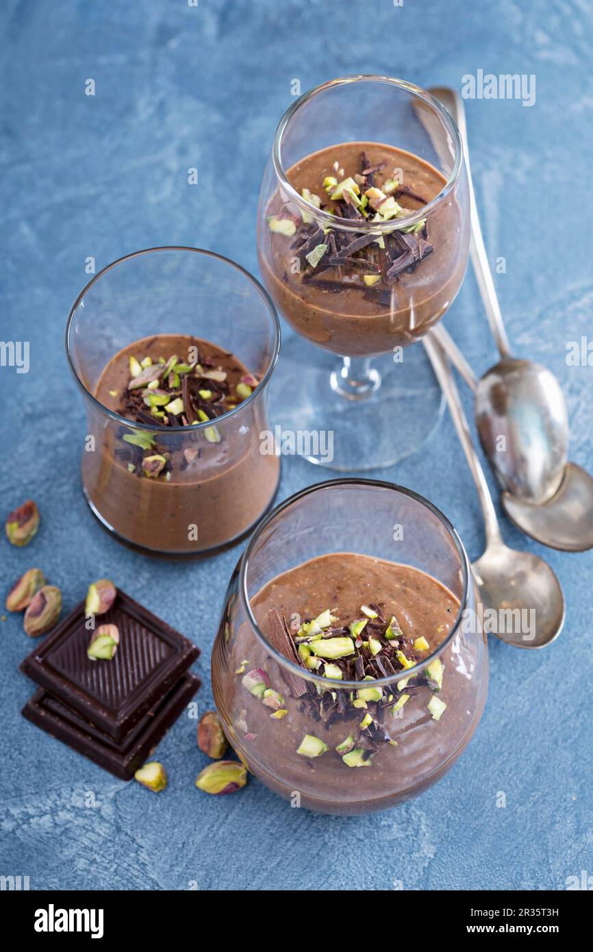 Vegan dark chocolate mousse with almond milk and pistachios Stock Photo