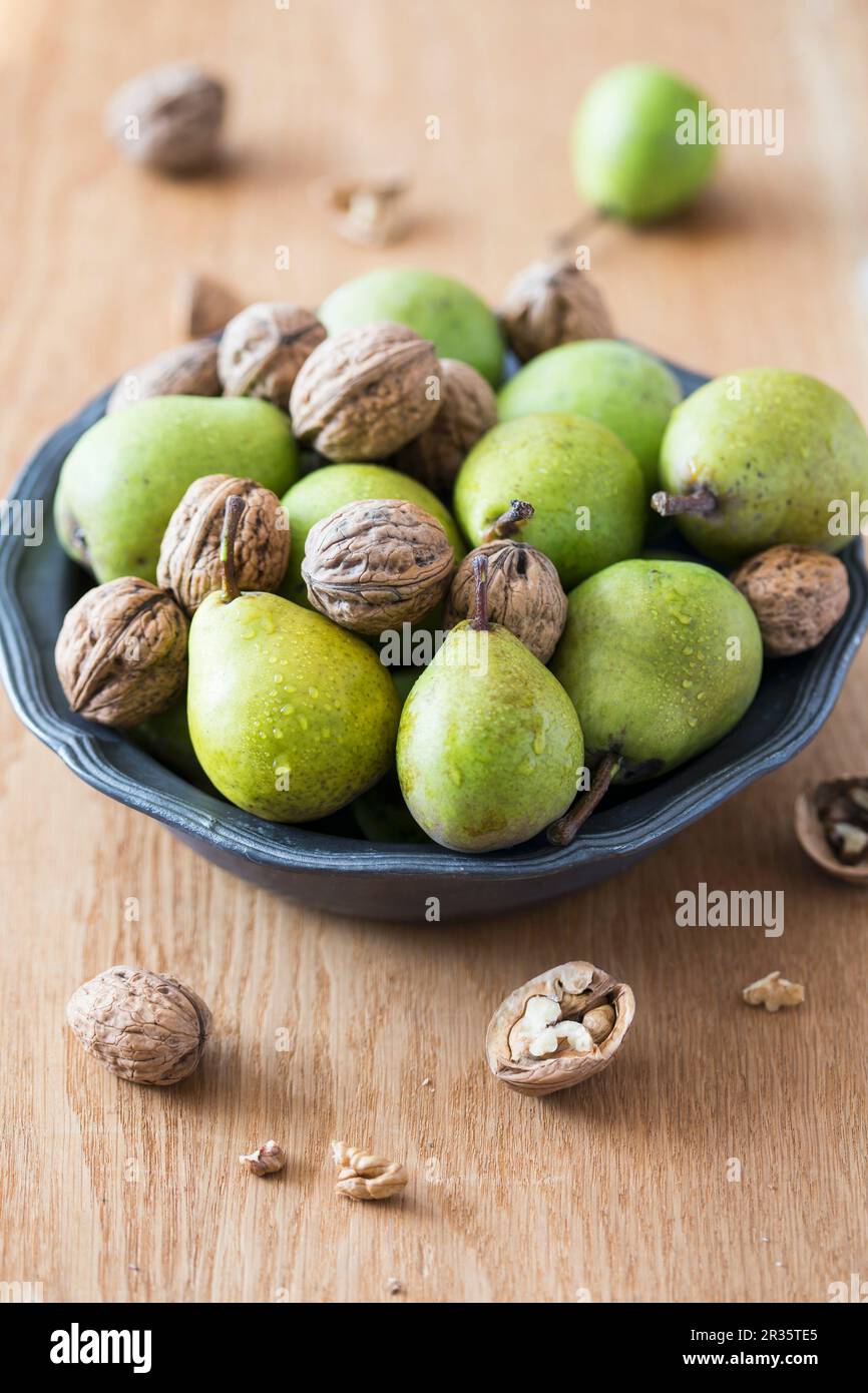 Fresh pears and walnuts in a bowl Stock Photo