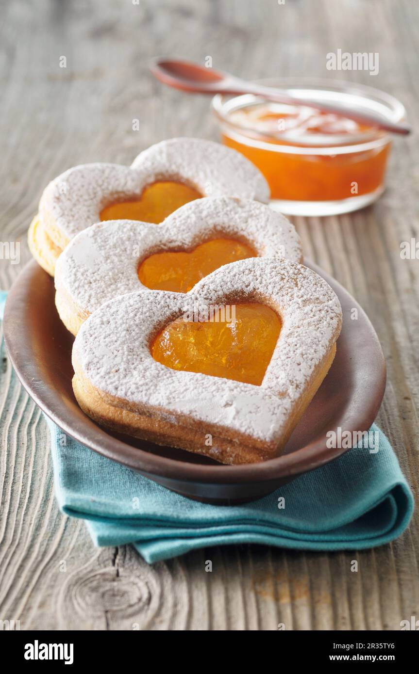 Heartshaped biscuits with apricot jam Stock Photo Alamy