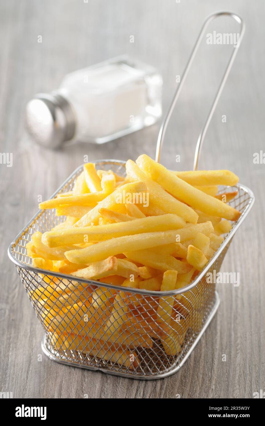 Chips in deepfrying basket Stock Photo Alamy
