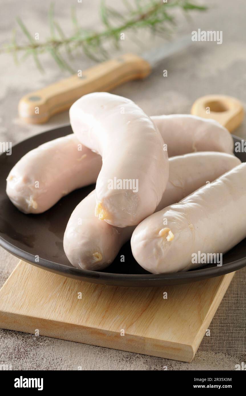 White sausages on a black plate Stock Photo