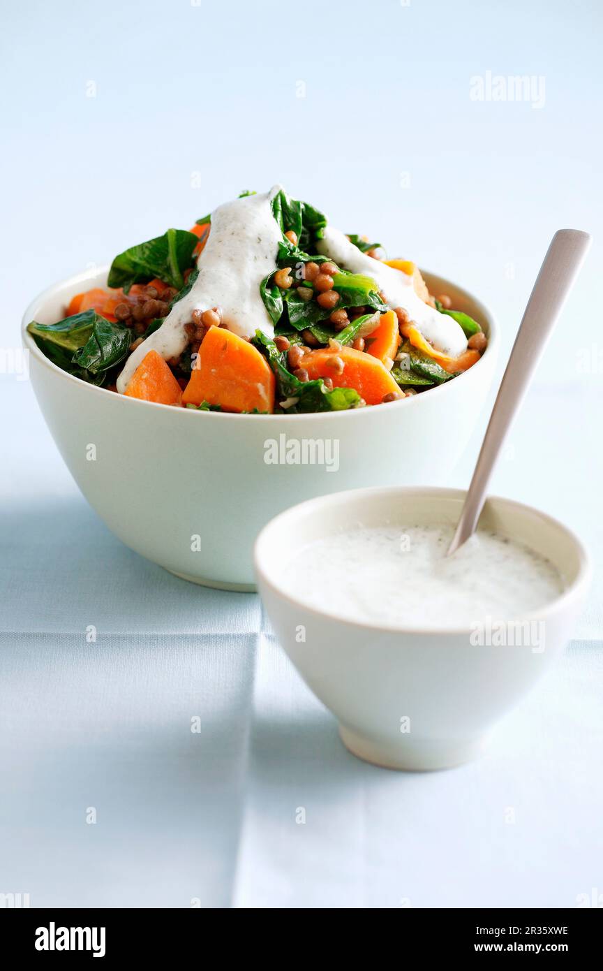 Spinach salad with papaya and yoghurt dressing Stock Photo Alamy