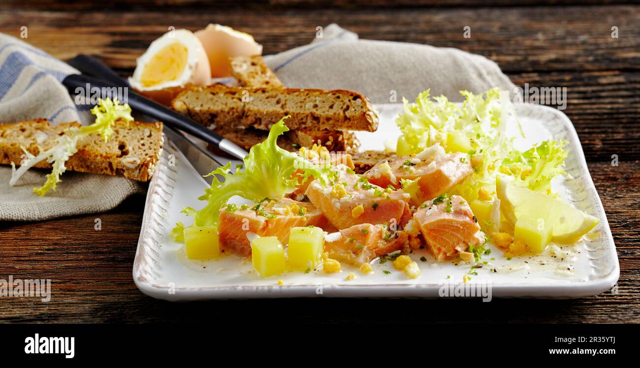 Char salad with potatoes and frisee lettuce Stock Photo