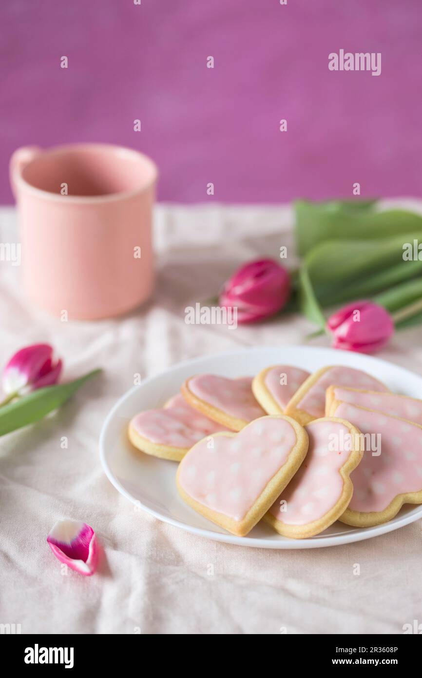 Pink heart-shaped biscuits for Mother's Day Stock Photo