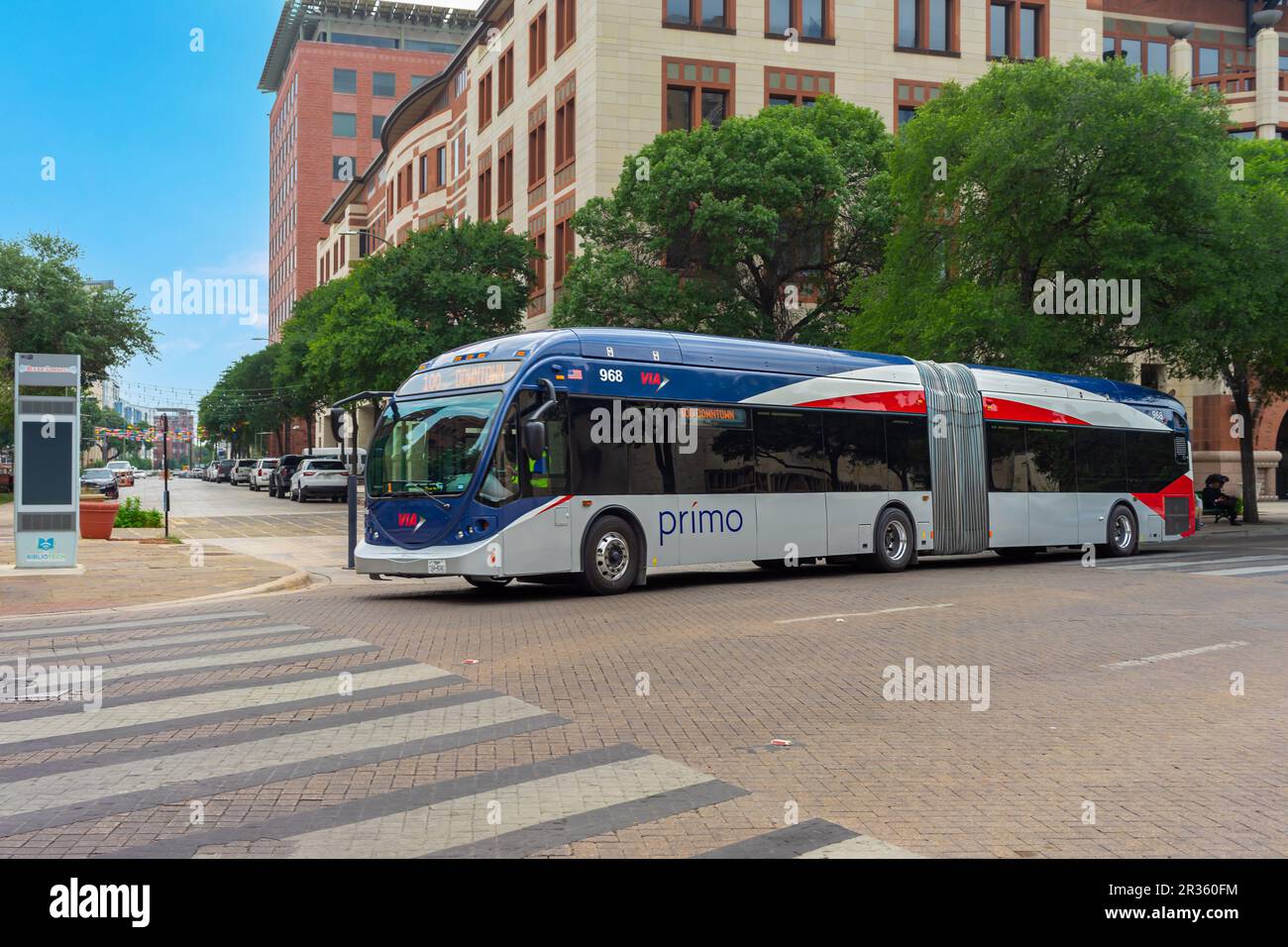 San Antonio, Texas, USA – May 8, 2023: A VIA Metropolitan Transit articulated bus traveling in downtown on Dolorosa Street in San Antonio, Texas. Stock Photo