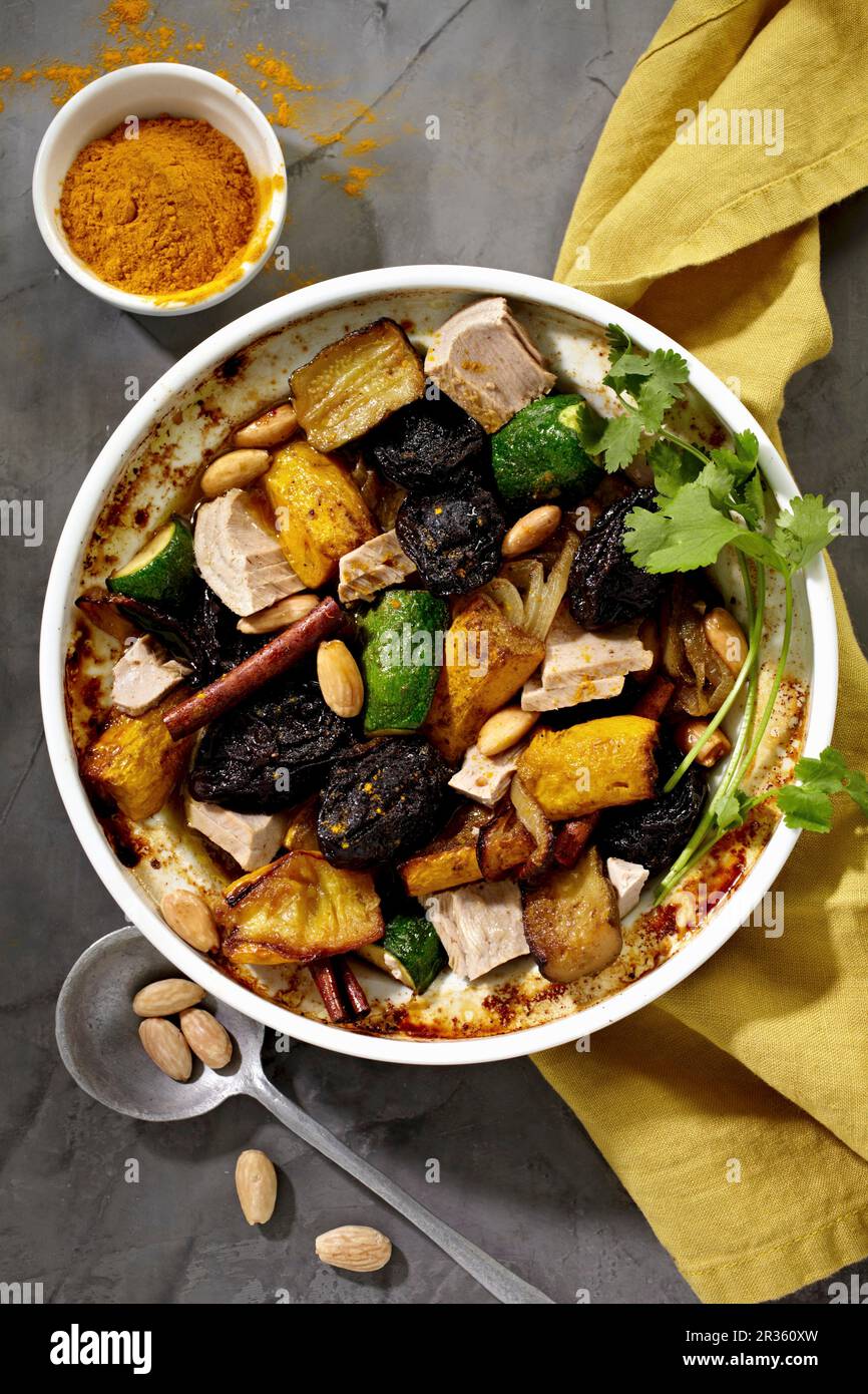 Tuna fish tagine with courgettes, fruits, almonds and spices Stock