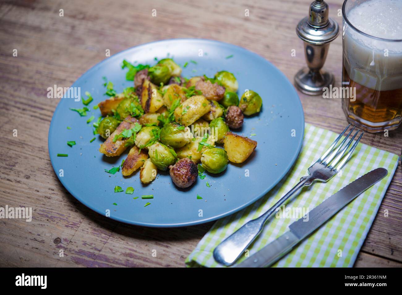 Fried potatoes with sausages and Brussels sprouts Stock Photo