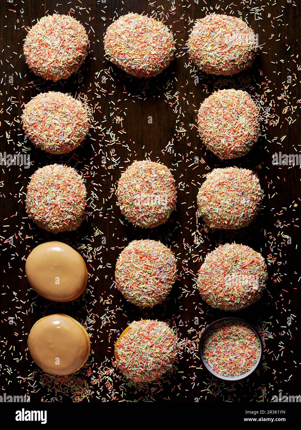 Caramel doughnuts with colourful sugar sprinkles Stock Photo