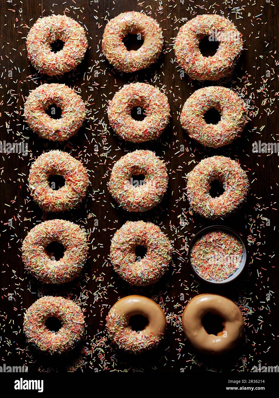 Caramel doughnuts with colourful sugar sprinkles Stock Photo