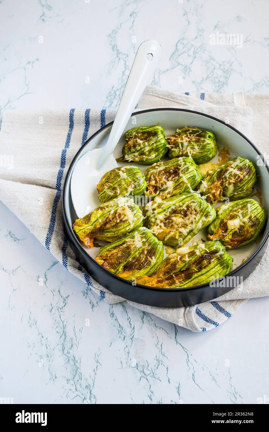 Stuffed, ovenbaked courgette flowers Stock Photo Alamy