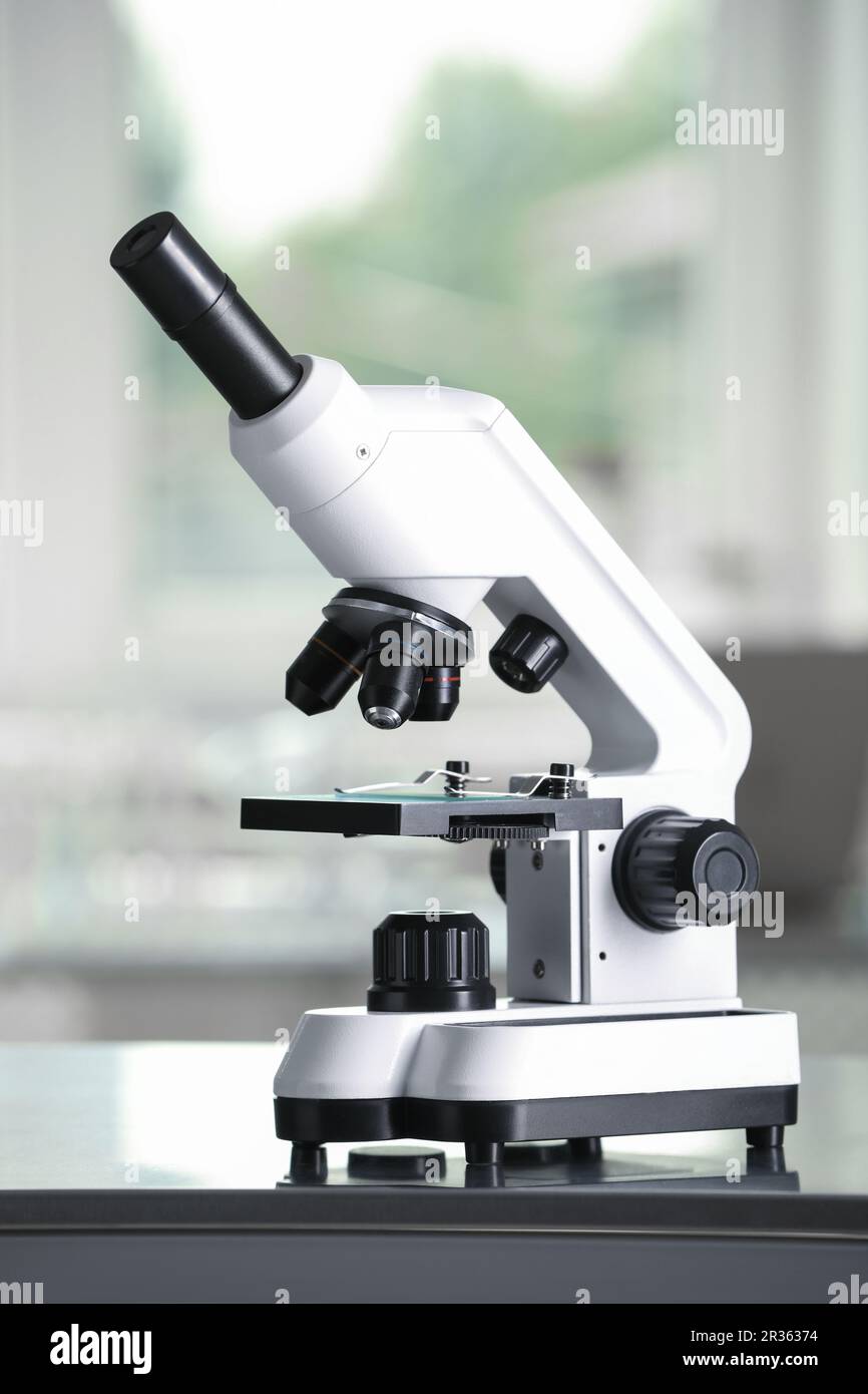 Modern medical microscope on metal table in laboratory Stock Photo - Alamy