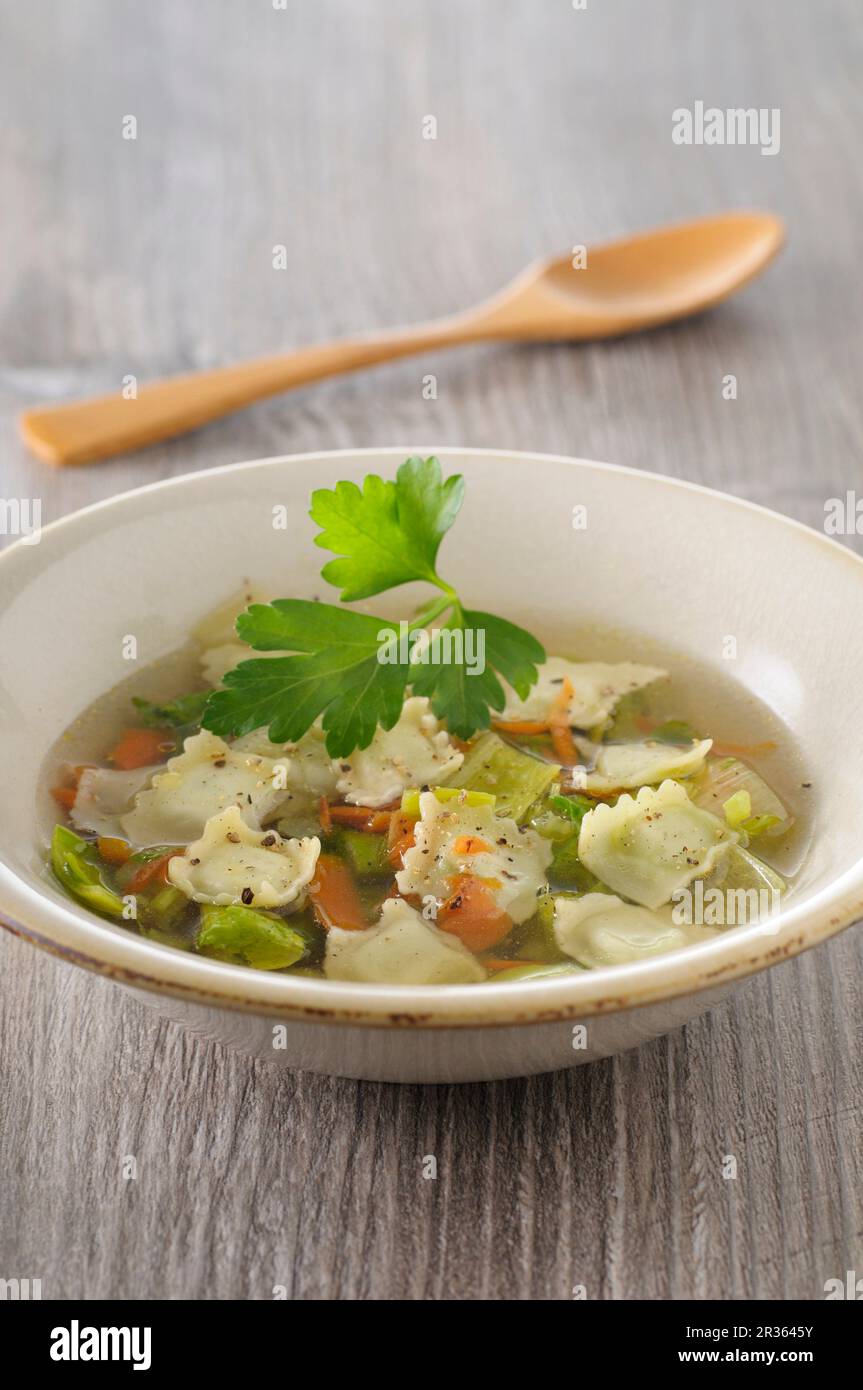 Clear vegetable soup with ravioli Stock Photo - Alamy