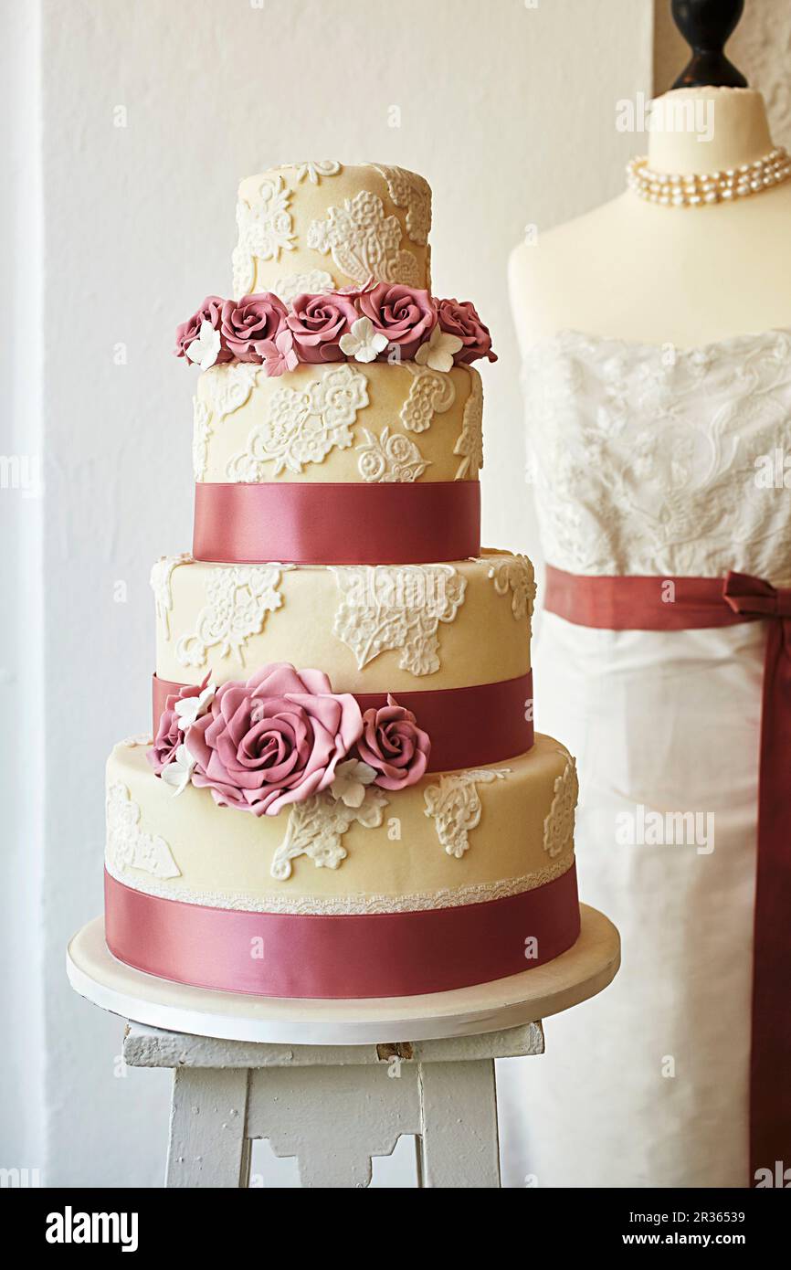 A wedding cake decorated with roses Stock Photo