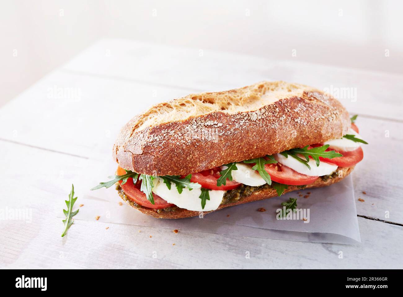 A baguette with mozzarella, tomato, pesto and rocket Stock Photo - Alamy