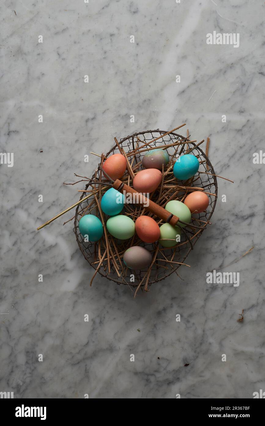 Easter eggs in a wire basket Stock Photo