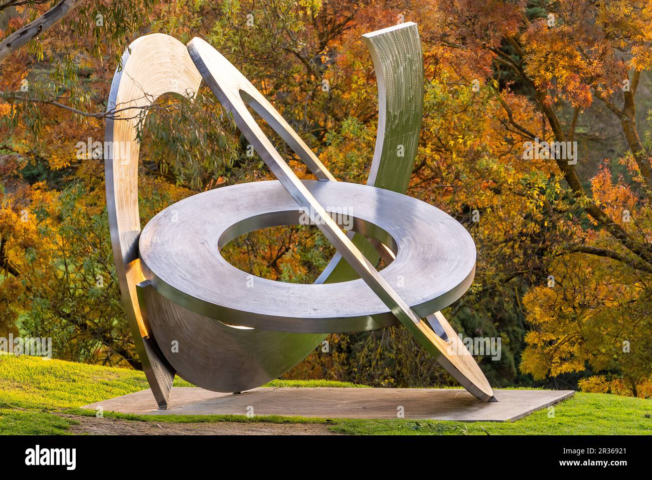 Inge King sculpture Rings of Saturn in front of autumn foliage at Heide Museum of Modern Art, Victoria, Australia. Stock Photo