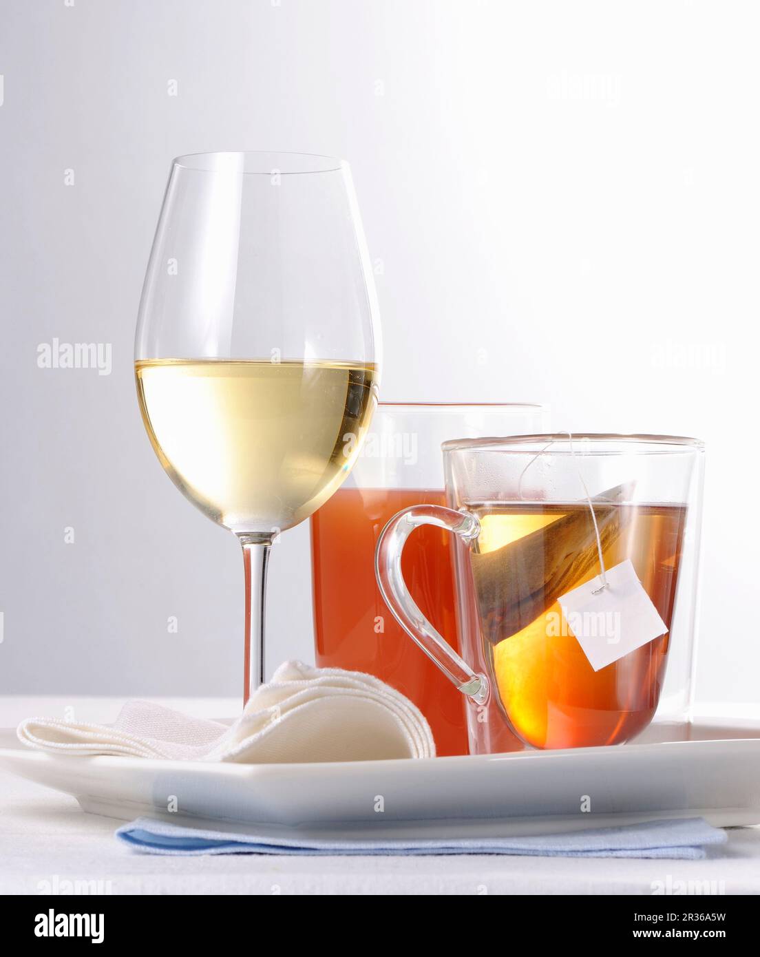 A glass of white wine, orange juice and a tea Stock Photo Alamy