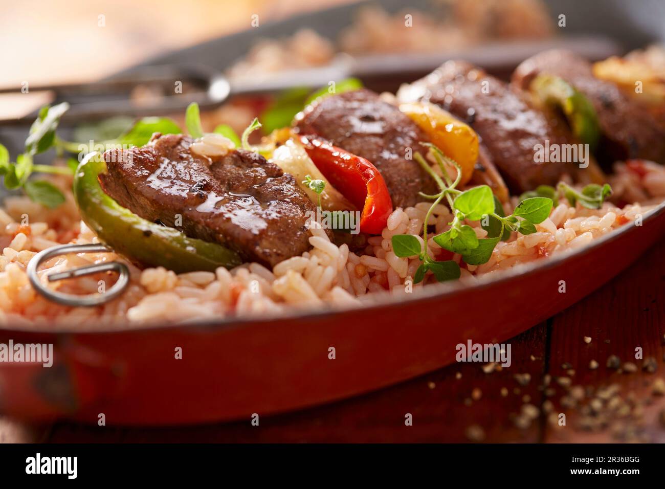 A lamb kebab with peppers on a bed of rice Stock Photo Alamy