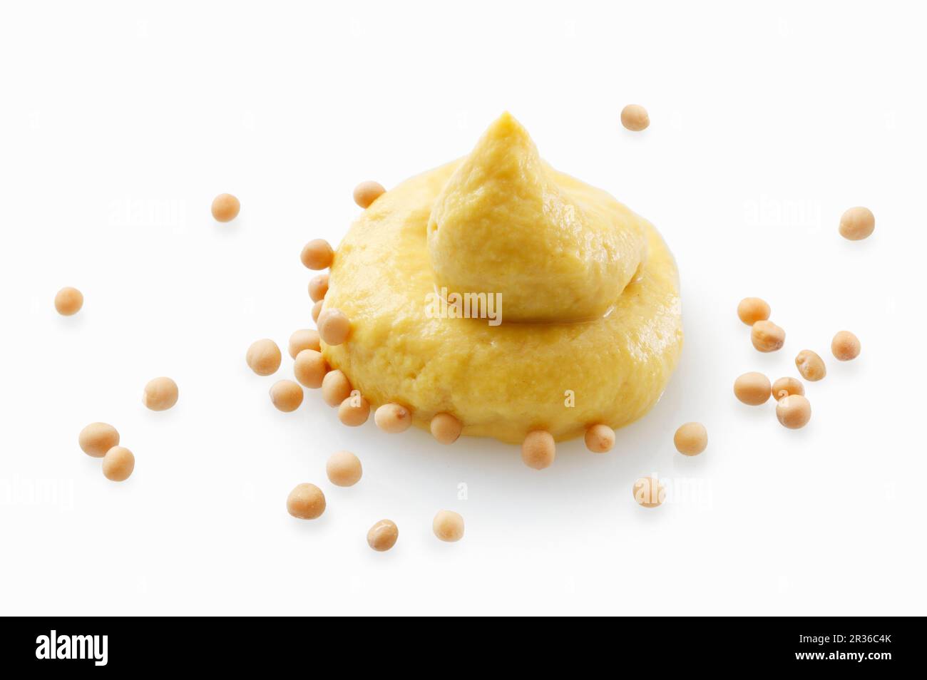 A dollop of mustard and mustard seeds Stock Photo