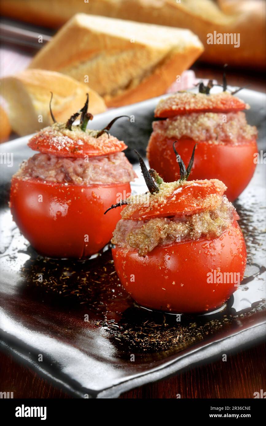Stuffed tomatoes served with baguette Stock Photo