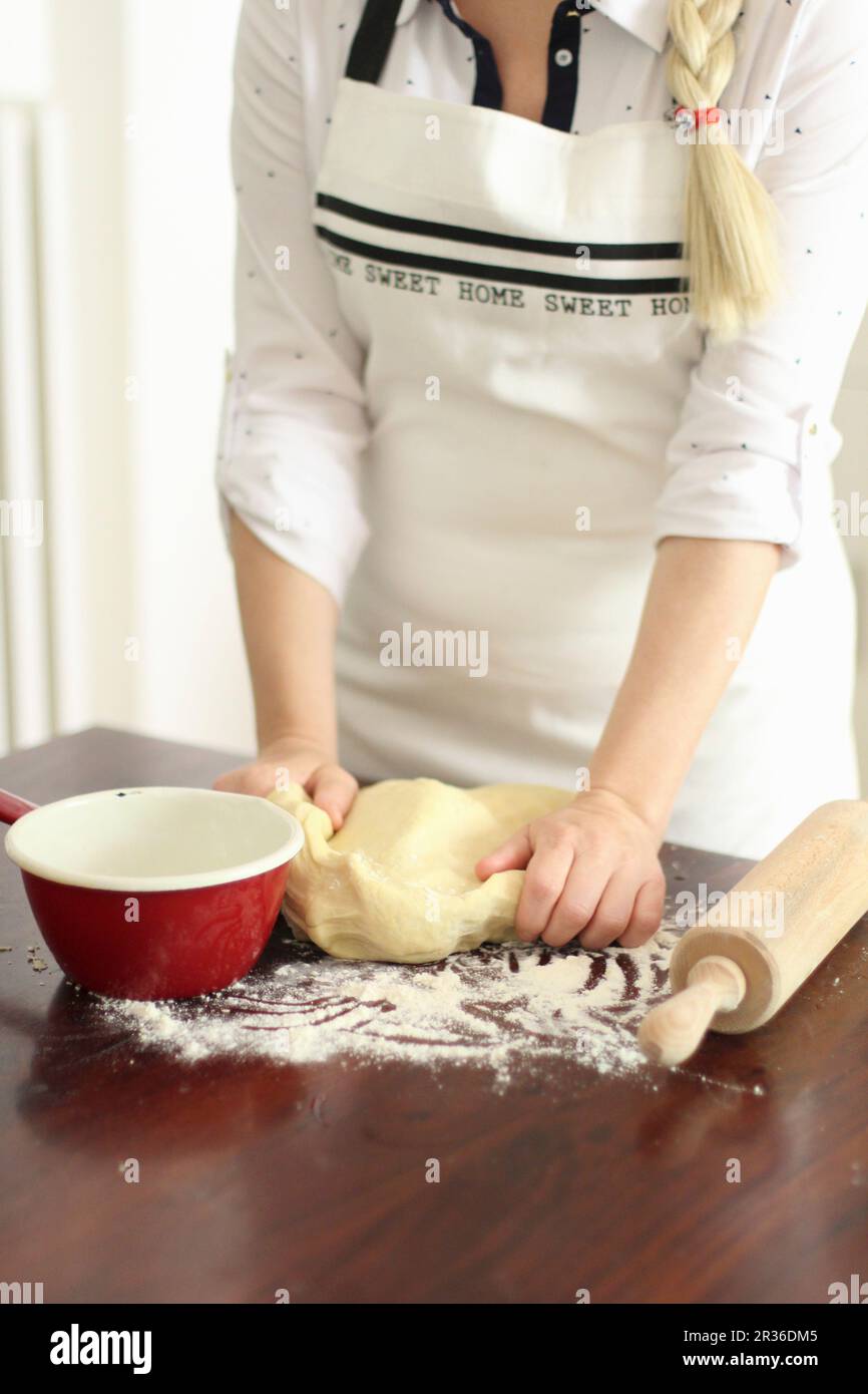 Woman Kneading Dough on Floured Counter in Kitchen Stock Photo - Alamy