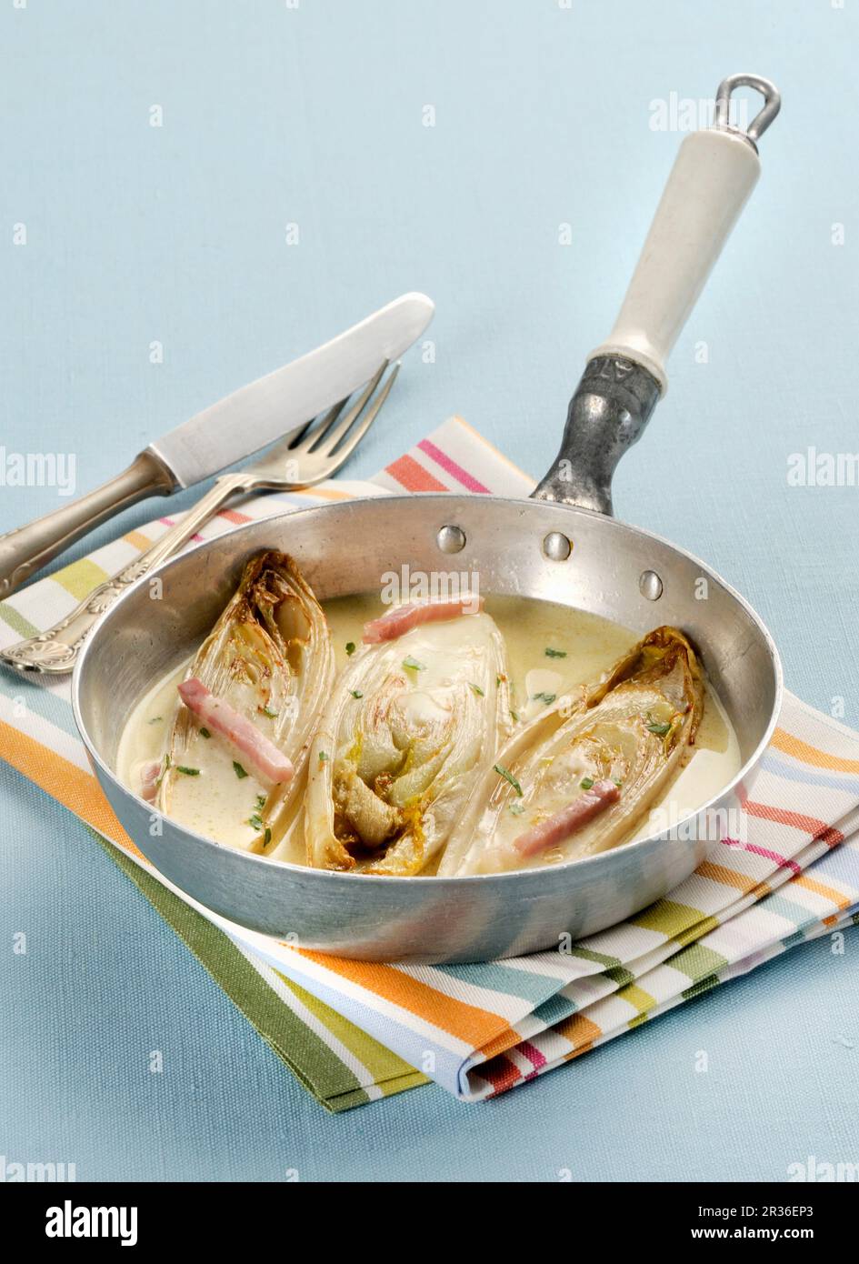 Braised chicory in a white wine sauce Stock Photo