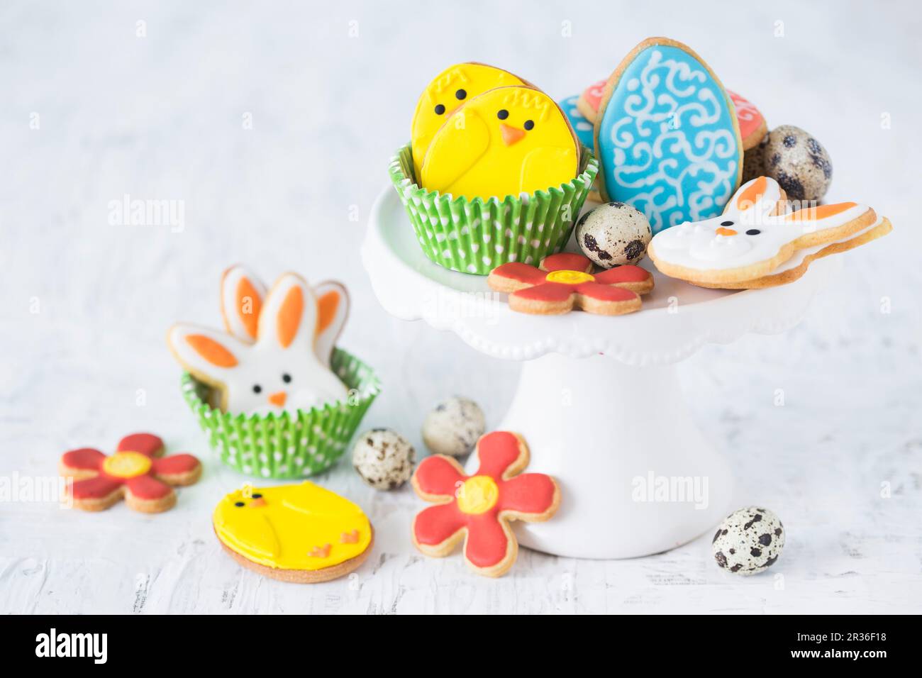 Colourful Easter biscuits and quails egg's on a cake stand Stock Photo
