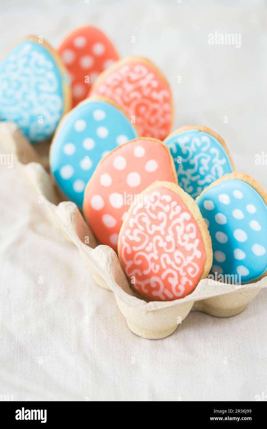 Colourful Easter egg biscuits in an egg box Stock Photo