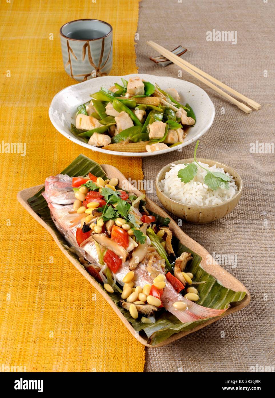 Steamed pandora in a banana leaf, and stir-fried chicken with vegetables Stock Photo