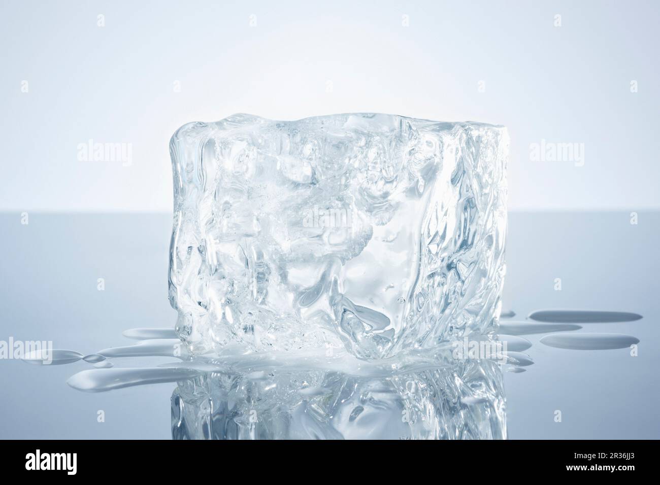 A block of ice on a reflective surface Stock Photo - Alamy