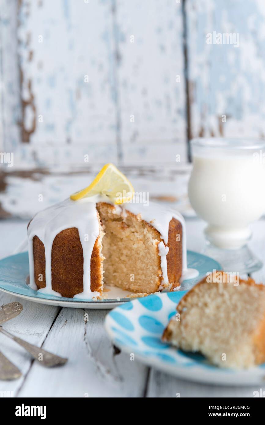Vegan lemon drizzle cake with white icing Stock Photo Alamy