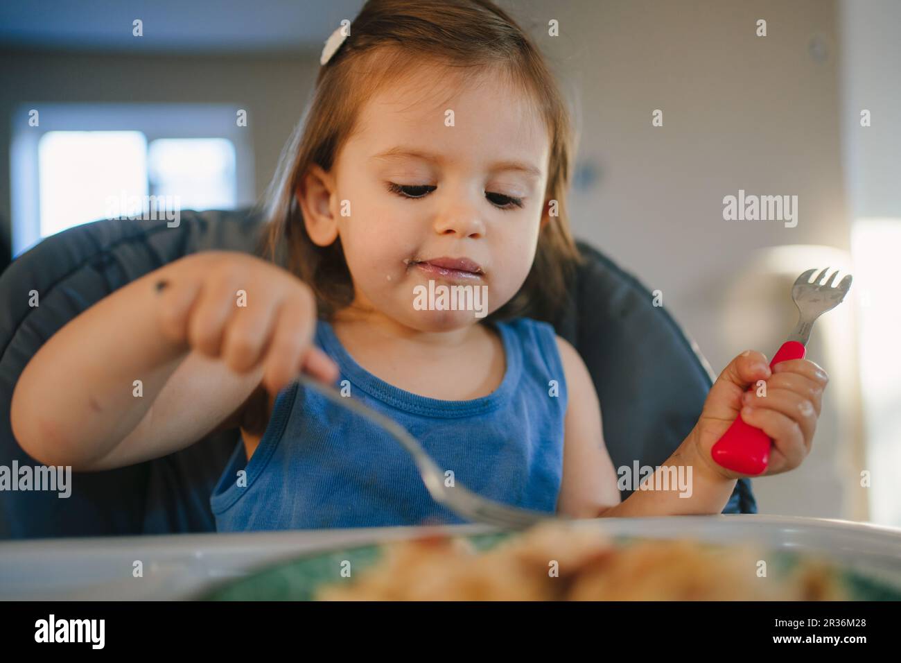 Child girl holding fork and enjoy eating delicious food, happy for ...