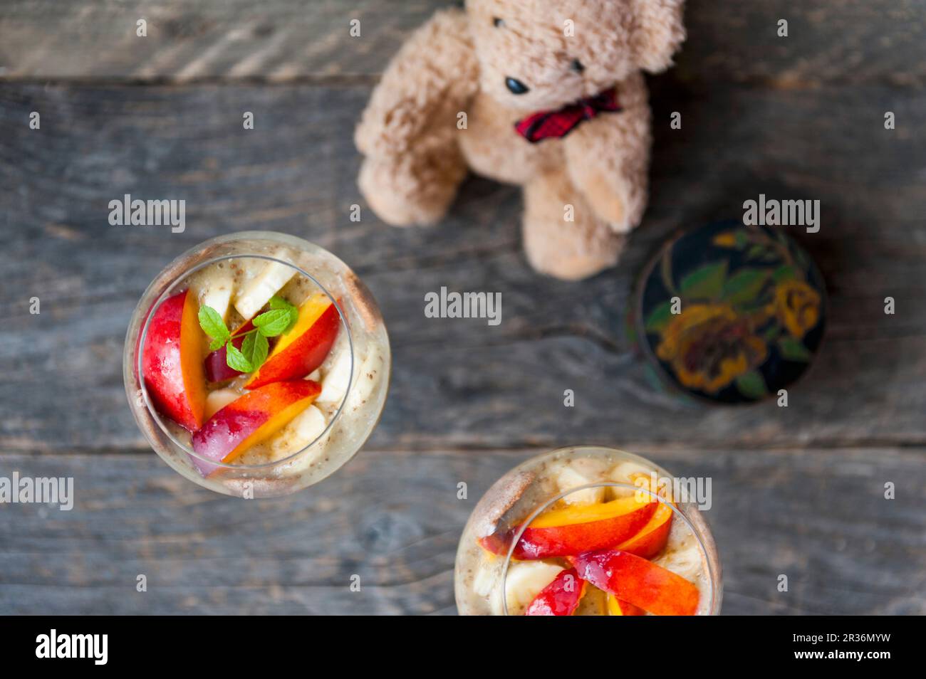 Chia pudding with bananas and nectarines in stemmed glasses (seen from above) Stock Photo