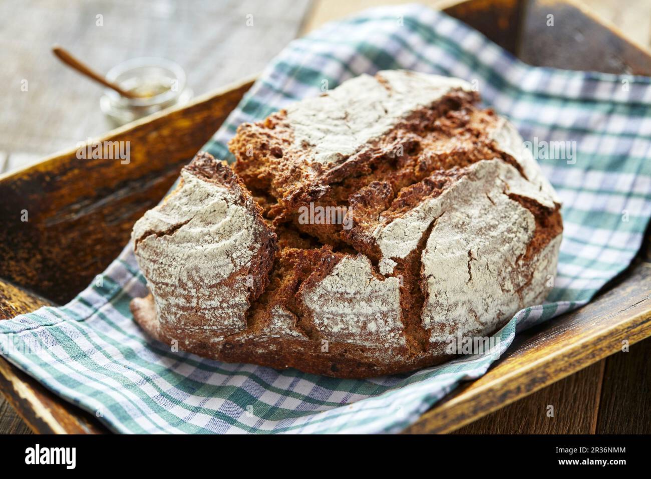 Rustic country bread on a checked napkin Stock Photo