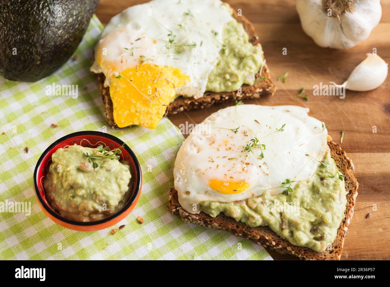 Multi-grain bread with guacamole and fried egg Stock Photo