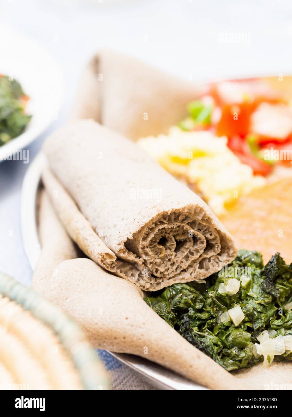 Rolled Ethiopian injera flatbread made with teff flour Stock Photo Alamy