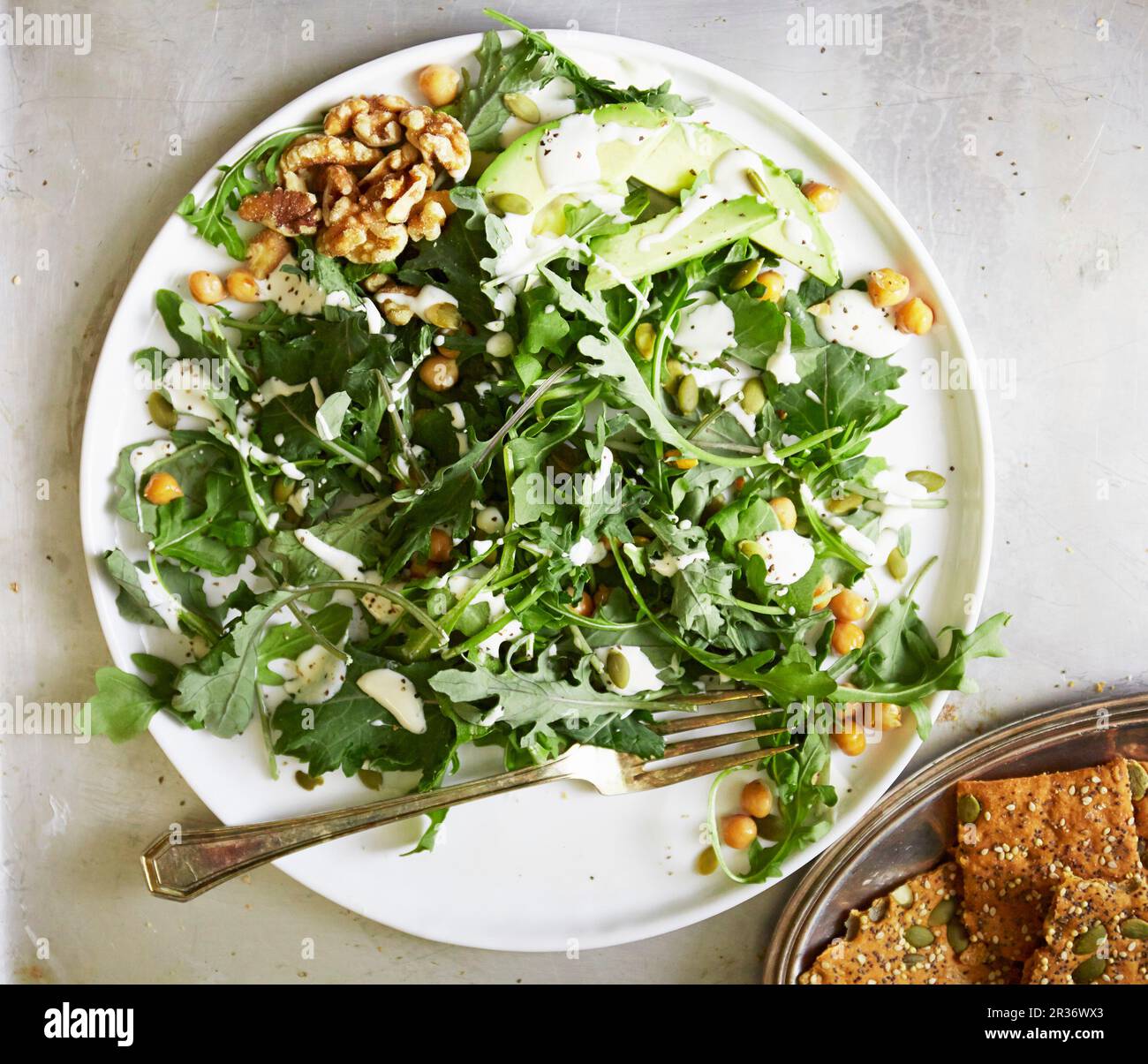 Kale and rocket salad with avocado and walnuts Stock Photo Alamy