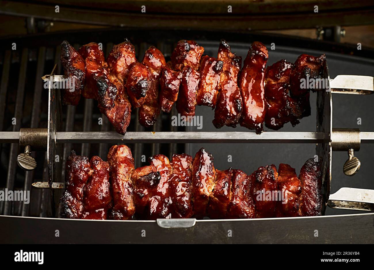 Chunks of pork being grilled on a rotisserie Stock Photo Alamy