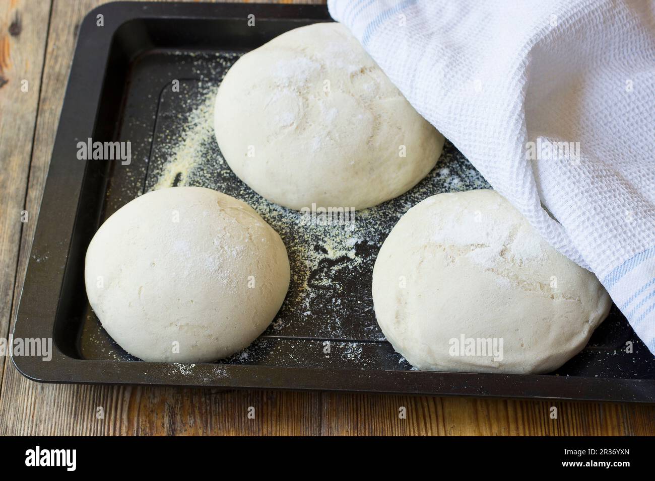 Pizza dough on a baking tay Stock Photo
