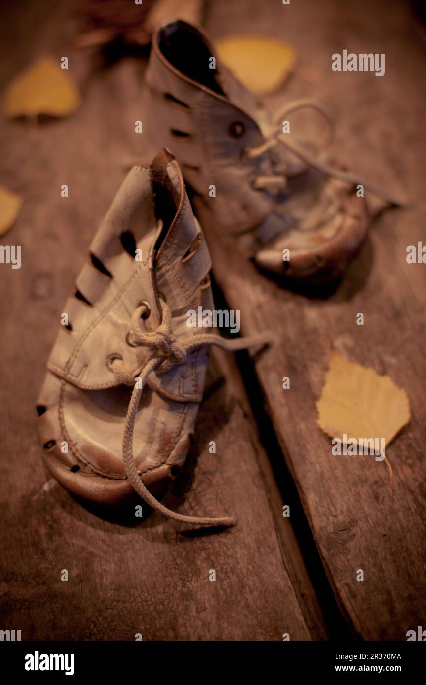 Old shoes for poor child Stock Photo