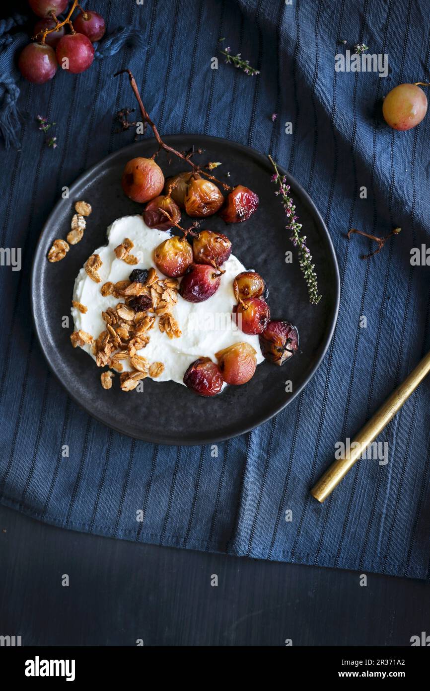Roasted grapes greek yogurt and granola Stock Photo Alamy
