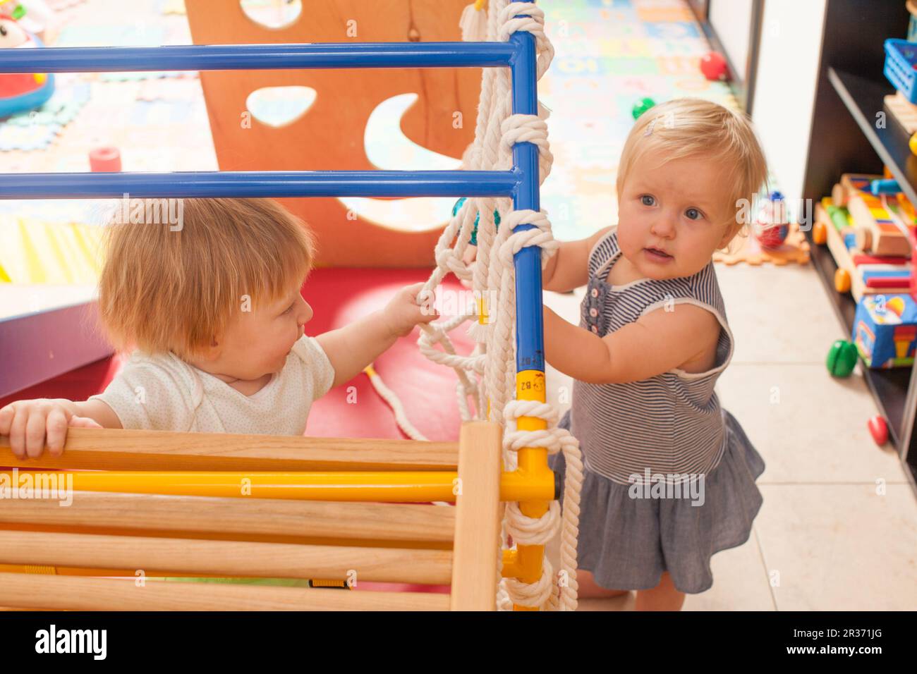 Boy and girl playing on playground equipment hi-res stock photography ...