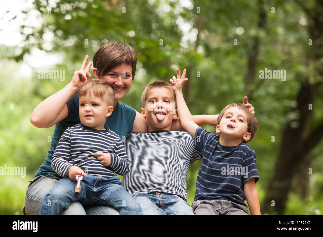 Mother with sons outdoors Stock Photo
