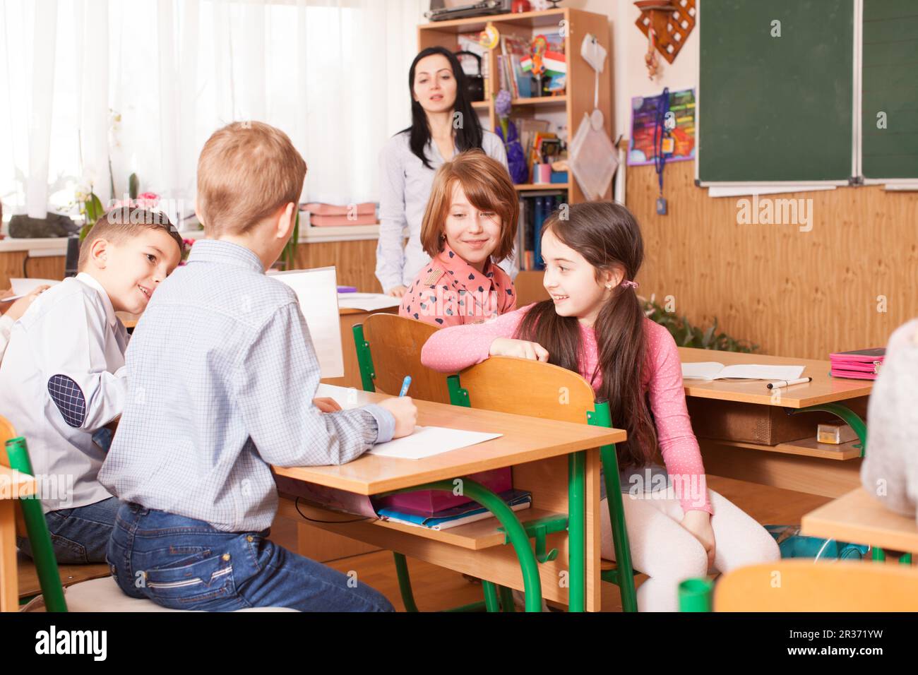 School girl explaining her classmate Stock Photo